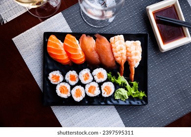 Traditional Japanese sushi platter. Delicious norimaki with salmon, nigiri sushi with tuna, salmon and shrimp - Powered by Shutterstock