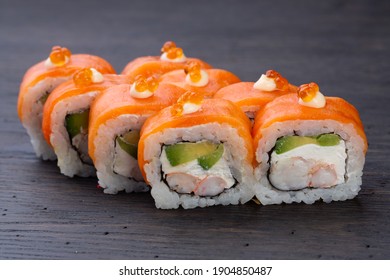 traditional Japanese sushi with shrimp, salmon, soft cheese, cucumber and red caviar, decorated with creamy sauce. Japanese kitchen. Japanese restaurant. - Powered by Shutterstock