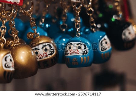 Traditional Japanese tourist souvenirs and gifts from Kyoto, Kansai, Japan, with daruma figures, kitsune fox, tengu mask, fridge magnets, toys figurines, key ring keychain, in a local vendor gift shop