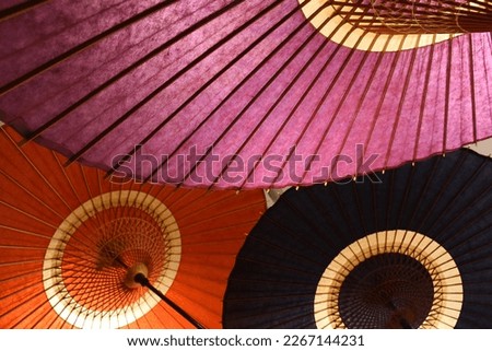 Traditional japanese umbrellas in various colors made of washi paper used for sun protection. Beautiful handmade crafts 