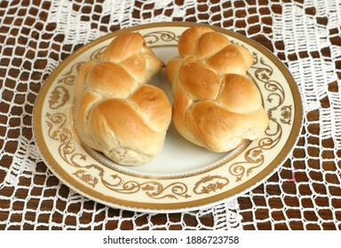 Traditional Jewish Cuisine. Challah, Braided Bread For Sabbath Dinner. On White Plate On Croched Tablecloth.