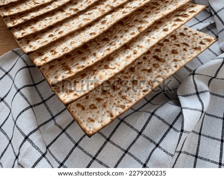 Traditional Jewish Kosher matzah bread on a rustic background. Passover holiday concept. Close up