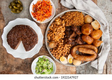 Traditional Jewish Shabbat  Meal (Cholent Hamin) slow cooked beef, potato, beans, brown eggs, wheat, chick pea and onion, served with pickles and Jewish dish (kugel) made of pasta