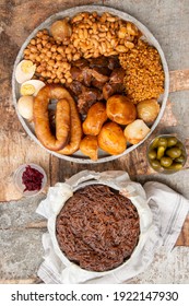 Traditional Jewish Shabbat  Meal (Cholent Hamin) Slow Cooked Beef, Potato, Beans, Brown Eggs, Wheat, Chick Pea And Onion, Served With Pickles And Jewish Dish (kugel) Made Of Pasta