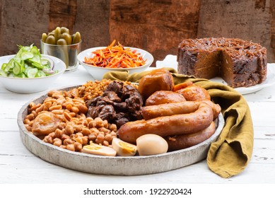 Traditional Jewish Shabbat  Meal (Cholent Hamin) slow cooked beef, potato, beans, brown eggs, wheat, chick pea and onion, served with salads, pickles and Jewish dish (kugel) made of pasta