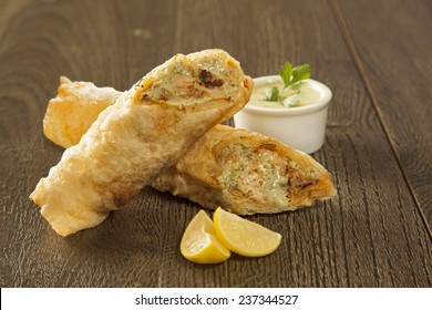 Traditional Kebab Paratha Roll Tikka Wrap Served On A Plate With Chutney, On A Wooden Background