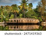 Traditional Keralan houseboat (kettuvallum) on the backwaters near Alappuzha (Alleppey) in southern Indian. The houseboats are a popular with tourists for overnight cruising.  