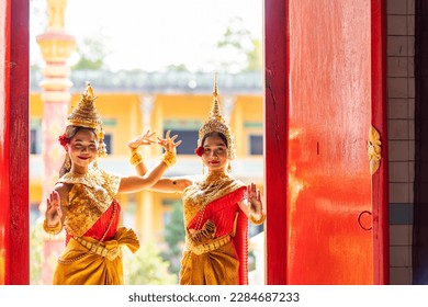 Traditional Khmer apsara dancers perform at a pagoda in Vietnam. The apsara represents an important motif in Khmer temples. People and art concept.
