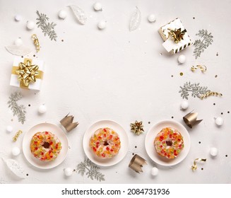 Traditional kings day bread called epiphany cake on white background with winter decorations. Roscon de reyes, spanish three kings Christmas sweet cake. Spanish typical dessert of Epiphany day.
