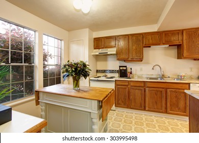 Traditional Kitchen With Tile Floor, Wood Cabinets, And White Interior Paint.