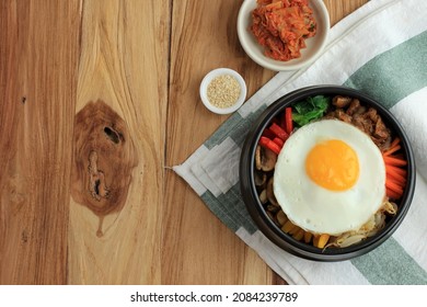 Traditional Korean Dish: Bibimbap Rice With Mix Sautee Vegetables, Beef,  And Egg. Served With Red Spicy Bibimbap Sauce And Sesame Oil. Copy Space For Text