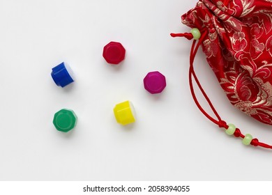 Traditional Korean game kit Gonggi. Colourful plastic stones with coloful pouch isolated on white background.
