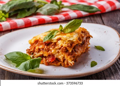 Traditional lasagna made with minced beef bolognese sauce and bechamel sauce  topped with basil leaves. - Shutterstock ID 373596733