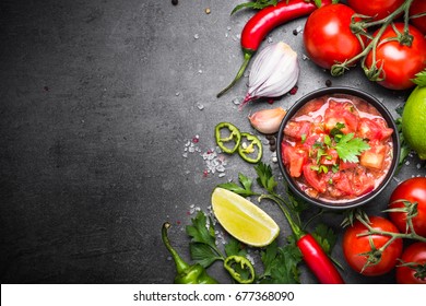 Traditional Latin American Mexican  Salsa Sauce And Ingredients On Black Stone Table. Top View Copy Space.