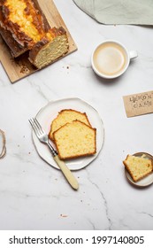 Traditional Lemon Cake With Coffee Flat Lay On The White Marble Table. Food Photo Of Glazed With Icing Pound Cake For Cook Book Cover Or Baker Blog 