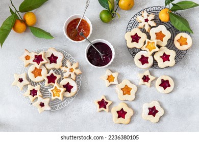 Traditional Linzer Christmas cookies filled with lingonberry jam and orange jam	

