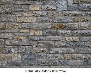 Traditional Local Stone House Wall In Street, Somerset, England. Maybe Blue Lias. Old.