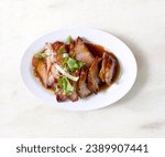 Traditional local style Char Siu or Char Siew - Honey barbecue roast pork on white plate of marble table - Chinese style grilled pork.