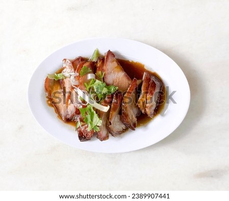 Traditional local style Char Siu or Char Siew - Honey barbecue roast pork on white plate of marble table - Chinese style grilled pork.