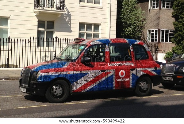 Traditional London\'s taxi painted in the colors of\
the English flag: 08 of May\
2013
