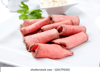 Traditional Lunch Meat With Sliced Cold Cuts Roast Beef And Remoulade As Closeup On A White Plate 