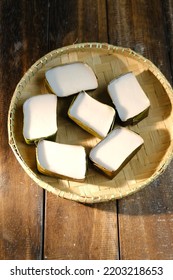 Traditional Malaysian Desert Called Kuih Tepung Pelita Or Kuih Tako On A Rustic Plate Over A Dark Background. Coconut Milk And Flour Prepared In Banana Leaves. Popular During Fasting Month Ramadan