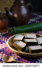 Traditional Malaysian Dessert Called Kuih Tepung Pelita Or Kuih Tako On A Rustic Plate Over A Dark Background. Coconut Milk And Flour Prepared In Banana Leaves. Popular During Fasting Month Ramadan