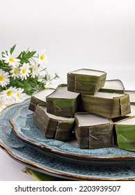 Traditional Malaysian Dessert Called Kuih Tepung Pelita Or Kuih Tako On A Rustic Plate Over A Dark Background. Coconut Milk And Flour Prepared In Banana Leaves. Popular During Fasting Month Ramadan