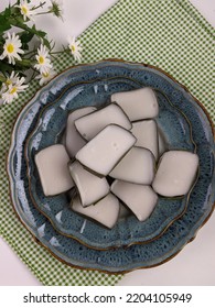 Traditional Malaysian Dessert Called Kuih Tepung Pelita Or Kuih Tako On A Rustic Plate Over A Dark Background. Coconut Milk And Flour Prepared In Banana Leaves. Popular During Fasting Month Ramadan