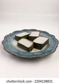 Traditional Malaysian Dessert Called Kuih Tepung Pelita Or Kuih Tako On A Rustic Plate Over A Dark Background. Coconut Milk And Flour Prepared In Banana Leaves. Popular During Fasting Month Ramadan