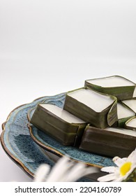 Traditional Malaysian Dessert Called Kuih Tepung Pelita Or Kuih Tako On A Rustic Plate Over A Dark Background. Coconut Milk And Flour Prepared In Banana Leaves. Popular During Fasting Month Ramadan