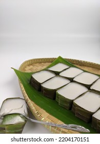 Traditional Malaysian Dessert Called Kuih Tepung Pelita Or Kuih Tako On A Rustic Plate Over A Dark Background. Coconut Milk And Flour Prepared In Banana Leaves. Popular During Fasting Month Ramadan