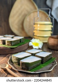 Traditional Malaysian Dessert Called Kuih Tepung Pelita Or Kuih Tako On A Rustic Plate Over A Dark Background. Coconut Milk And Flour Prepared In Banana Leaves. Popular During Fasting Month Ramadan