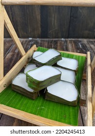 Traditional Malaysian Dessert Called Kuih Tepung Pelita Or Kuih Tako On A Rustic Plate Over A Dark Background. Coconut Milk And Flour Prepared In Banana Leaves. Popular During Fasting Month Ramadan