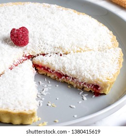 Traditional Manchester Tart On White Marble With Raspberries And Coconut