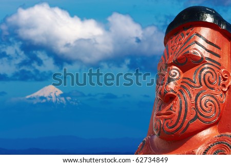 Traditional maori carving over Taranaki Mount background, New Zealand
