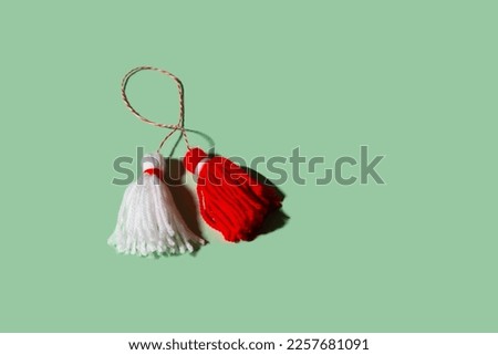 Traditional Martisor - symbol of holiday 1 March, Martenitsa, Baba Marta, beginning of spring and seasons changing in Romania, Bulgaria, Moldova. Greeting and post card for holidays