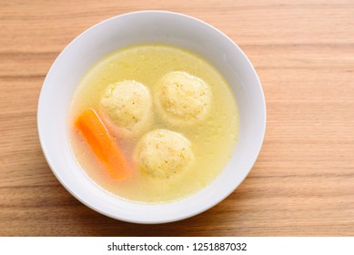 Traditional Matzah Balls (Kneidlach) Soup.White Bowl With Authentic Matzo Ball Chicken Taste Hot Soup ( Bouillon ) Tradition Jewish Food For Passover, Shabbos And Every Day. Top View, Overhead.