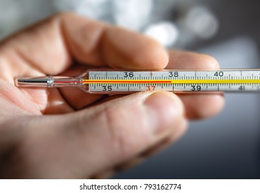 Traditional Medical Thermometer For Measuring Body Temperature In Hand.