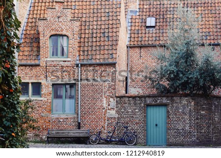 Traditional medieval architecture, old brick house with red tiled roof in town Ghent, Belgium, Europe