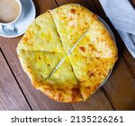 Traditional Megrelian khachapuri, open pie with sulguni cheese added on top. National Georgian cuisine