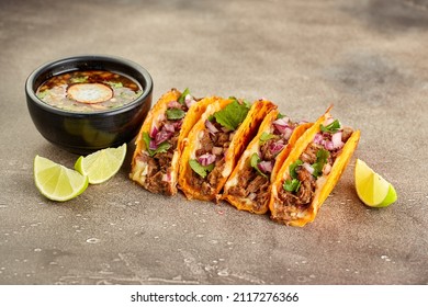 Traditional Mexican Birria Consome Soup And Four Taco With Stewed Beef.