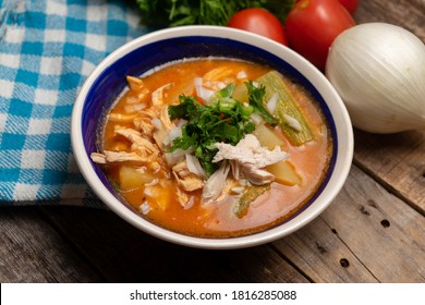 Traditional Mexican Chicken Soup With Vegetables And Rice On Wooden Background