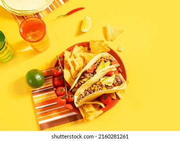 Traditional Mexican Corn Tacos With Meat, Vegetables, Avocado, Beans, Salsa And Nachos. Served With Various Sauces And Drinks. Top View. Big Family Gatherings. Copy Space