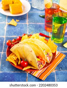 Traditional Mexican Corn Tacos With Meat, Vegetables, Avocado, Beans, Salsa And Nachos. Served With Various Sauces And Drinks. Big Family Gatherings