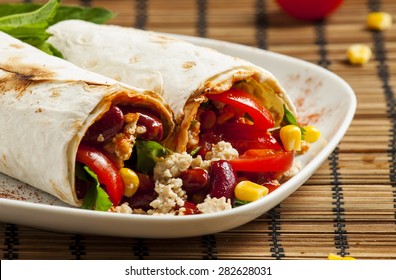 Traditional Mexican food, burritos with meat and beans, selective focus