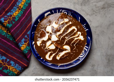Traditional mexican food. Enchiladas with mole sauce also called Enmoladas on grey background