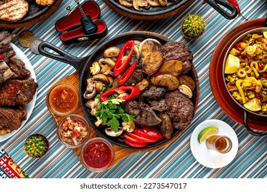 Traditional mexican food. Meat Mega grill in a pan of beef, lamb, chicken liver and bovine eggs. Colorful Food Table Celebration Delicious Party Meal Concept. 