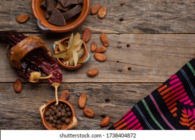 Traditional mexican ingredients for mole sauce on wooden background