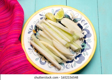 Traditional mexican jicama and cucumber cutted on turquoise background